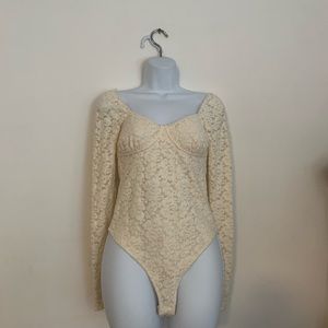 NEW WITH TAGS- Cream colored floral bodysuit, soft to the touch Size-XS